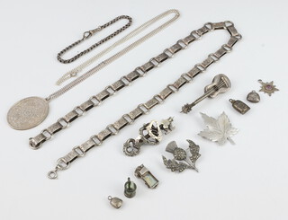 A white metal necklet, a 1977 925 silver Jubilee pendant hung on a fine chain, 6 charms, 3 brooches and a small white metal bracelet 