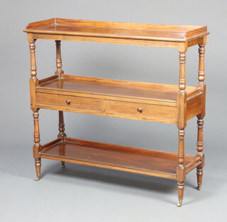 A 19th Century rectangular mahogany 3 tier buffet with 3/4 gallery and 2 drawers with turned handles, raised on brass caps and casters 102cm h x 107cm w x 35cm d  