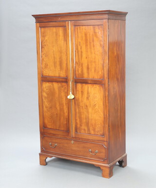 A 19th Century mahogany wardrobe with moulded and dentil cornice enclose by a panelled door, the base with dummy drawer, raised on bracket feet 178cm h x 98cm w x 47cm d 