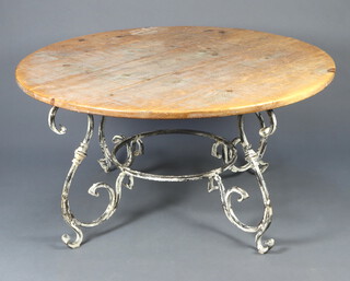 A 20th Century Rococo style circular pine and wrought iron dining table, raised on verdigris wrought iron base 78cm h x 149cm diam. 