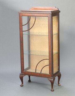 An Art Deco mahogany display cabinet with raised back, fitted adjustable shelves enclosed by astragal glazed panelled doors, on cabriole supports 128cm h x 58cm w x 32cm d 