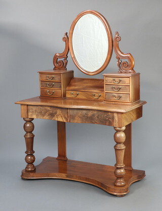 A Victorian mahogany Duchess dressing table of serpentine outline, with oval bevelled plate mirror, 2 secret drawers, 1 long and 6 short drawers, raised on turned supports with undertier 154cm h x 109cm w x 50cm d 