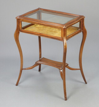 An Edwardian rectangular mahogany bijouterie table of serpentine outline and bevelled glass panel to the top, raised on cabriole supports with undertier 76cm h x 59cm w x 42cm d  