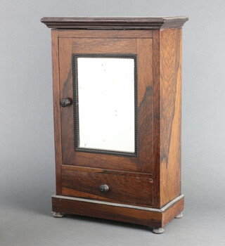 A 19th Century rosewood "apprentice" cabinet with moulded cornice, enclosed by mirror panelled door, the base fitted a drawer, raised on turned supports 44cm h x 28cm w x 14cm d 