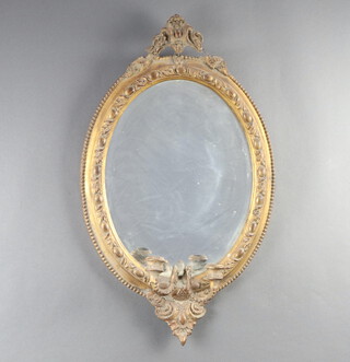 A 19th Century oval bevelled plate wall mirror contained in a gilt frame with sconces to the base 65cm h x 38cm w 