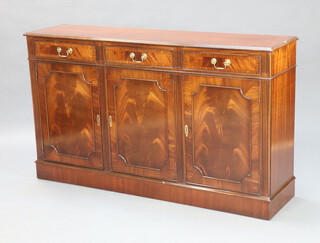 A Georgian style mahogany sideboard fitted three drawers above a double cupboard, raised on a platform base 89cm x 152cm x 38cm