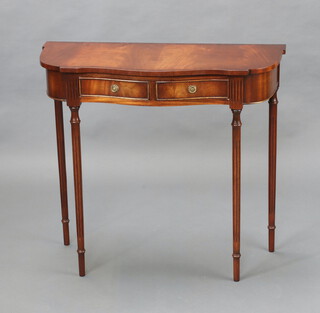 A Georgian style crossbanded serpentine mahogany side table fitted 2 drawers, raised on turned and fluted supports 72cm x 80cm x 34cm - light scratches in places