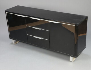 A black laminate sideboard with three long drawers flanked by cupboards raised on metal bracket feet