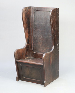 A pine and plywood lambing style winged arm chair