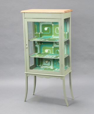 An Edwardian blue painted display cabinet, the interior fitted shelves, raised on out swept supports 123cm x 59cm x 31cm