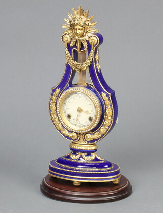 A Franklin Mint striking clock contained in a porcelain lyre shaped case, 39cm x 16cm x 10cm