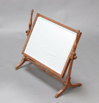 A 1920's rectangular bevelled plate dressing table mirror contained in a light oak swing frame 52cm h x 59cm w x 27cm d 