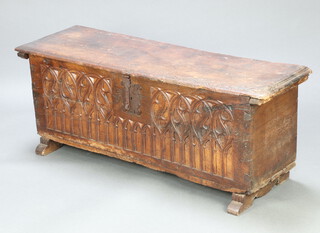 A 16th century and later Century Spanish Gothic carved fruitwood coffer with iron hinged lid and shaped iron lock plate and locking bar. The front panel of carved arcaded tracery in the manner of a Triforium, raised on replacement sleigh supports 54cm h x 144cm w x 43cm d 