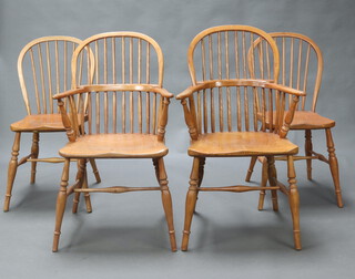 A set of 4 20th Century elm stick and hoop back dining chairs - 2 carvers 98cm h x 56cm w x 35cm d, 2 standard 91cm h x 40cm w x 40cm d, raised on turned supports with H framed stretcher 