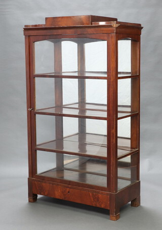 A Biedermeier style mahogany bookcase fitted adjustable shelves, the stepped top fitted a secret drawer with mirrored back, enclosed by glazed panelled doors, the base with secret drawer and raised on square supports 167cm h x 97cm w x 48cm d 