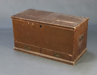 A 19th Century pine trunk with hinged lid and iron drop handles, interior fitted a drawer and the base with 2 drawers, brass countersunk handles, 48cm h x 93cm w x 47cm d 