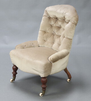 A Victorian buttoned nursing chair with metal frame, upholstered in mushroom coloured material, raised on turned supports, ceramic casters 81cm h x 54cm w x 43cm d (seat 20cm x 24cm) 