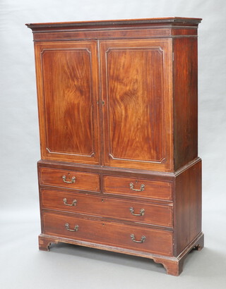 A Georgian inlaid mahogany linen press with moulded and dentil cornice, interior fitted 4 trays enclosed by panelled doors, the base fitted 2 long and 2 short drawers, raised on bracket feet 186cm h x 124cm w x 58cm d  