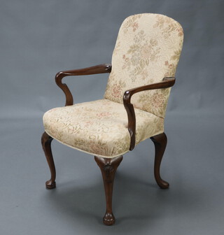 A 1940/50's Queen Anne style walnut open armchair, the seat and back upholstered in yellow floral material, raised on cabriole supports 101cm h x 56cm w x 50cm d (seat 32cm x 35cm) 