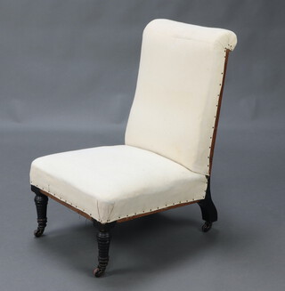A Victorian nursing chair upholstered in white material, raised on turned ebonised supports 78cm h x 48cm w x 54cm d (seat 21cm x 29cm) 