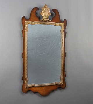 A 1950's Chippendale style rectangular plate mirror contained in a walnut frame 89cm h x 47cm 