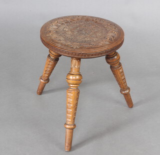 A circular hardwood 3 legged stool, the top carved a heptagram, 28cm h x 31cm diam.   
