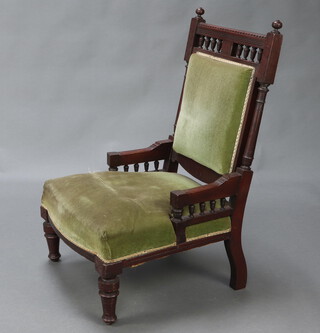 A late Victorian carved mahogany show frame chair with bobbin turned decoration, seat and back upholstered in green material, on turned supports 96cm h x 56cm d x 60cm d (seat 30cm x 37cm) 