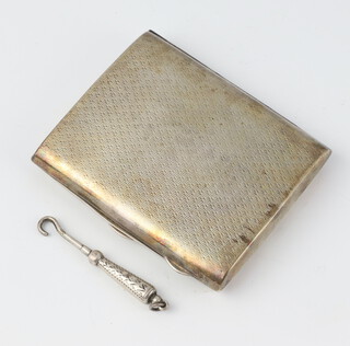 A silver engine turned cigarette case together with a miniature silver handled button hook, gross weight 78 grams 