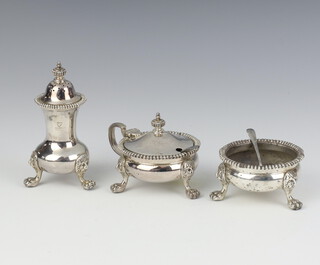 A 3 piece condiment set with beaded decoration, lion mask and claw feet, Birmingham 1957, 274 grams 