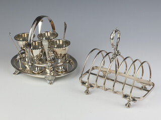 An Edwardian silver plated 4 piece egg cup set and a 7 bar toast rack 