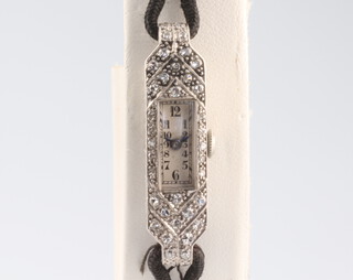 An Art Deco white metal diamond set cocktail watch 33mm on a silk strap 