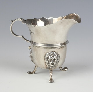 A silver cream jug with lion mask knees, pad feet and S scroll handle, Chester 1911 138 grams, 9cm 