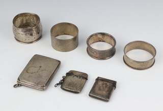 An Edwardian silver vesta, Chester 1906, 1 other, 4 napkin rings and a match book holder, 122 grams 