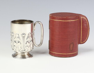 A silver christening mug with repousse acanthus decoration, London 1926, 8.5cm, 112 grams, by the Goldsmiths and Silversmiths Co., in a fitted shaped box  