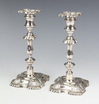 A pair of Georgian design cast silver candlesticks and sconces, Sheffield 1968, maker James Dixon and Sons 24cm