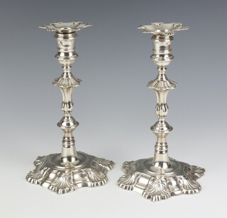 A pair of George II silver candlesticks with waisted stems London 1749 and 1750, 23cm, 1322 grams