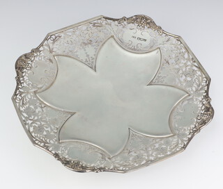 A silver pierced tazza decorated with scrolls, flowers and grapes, Sheffield 1928, 28cm, 540 grams 