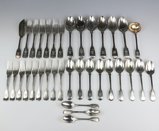 A matched canteen of William IV and Victorian fiddle and thread pattern cutlery with armorial, 6 table spoons London 1847 and 1851, 9 dessert spoons London 1834, 1851 and 1897, 6 dinner forks London 1851, 1854, 9 dessert forks London 1860, 1863 and 1897, a ladle, butter knife, 3 tea spoons, all rubbed marks, 2342 grams 