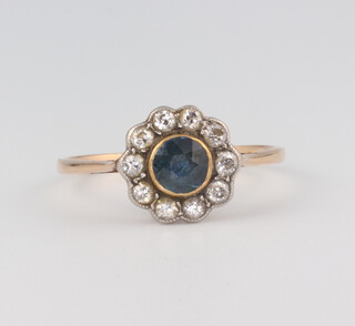 A yellow metal 18ct circular sapphire and diamond cluster ring, the centre stone approx. 0.20ct, 1.9 grams, size O  