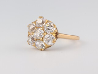 A yellow metal stamped 18ct, 7 stone diamond cluster ring, approx. 1.5ct, 4.7 grams, size N 1/2 