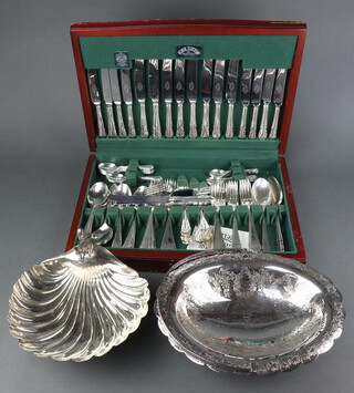 A mahogany finished canteen containing a set of silver plated cutlery, 89 pieces, together with a plated nut bowl and swing handled basket 
