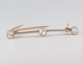 A yellow metal 3 stone diamond bar brooch with 3 mine cut stones, approx. 1.2ct, 45mm, 3 grams