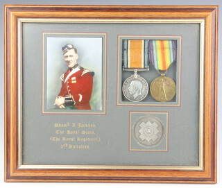 A First World War pair of medals to BDSMN A.Jackson The Royal Scotts, together with a silver medallion and a reproduction photograph, framed as one  