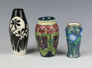 A modern Moorcroft vase with stylised flowers 10cm, a black and white ditto 13cm and an enamelled vase decorated with flowers 9cm 