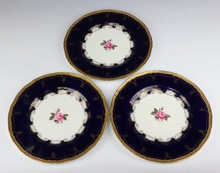 Three Royal Worcester plates with blue and gilt borders enclosing roses, decorated by I Lyn 27cm 