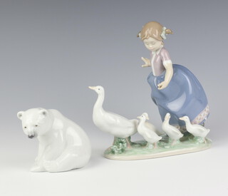 A Lladro figure of a seated polar bear cub 7cm, ditto group of a girl with family of geese 5503 18cm 