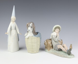 A Lladro figure of a dog in a basket 18cm, ditto of a lady 28cm and a reclining boy 15cm 