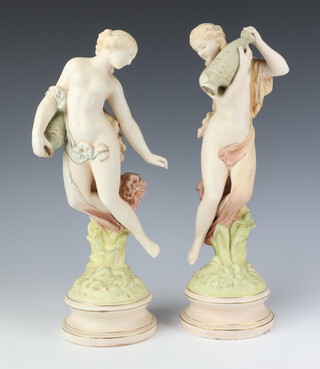 A pair of Dux figures of semi-clad ladies, raised on circular bases 38cm 