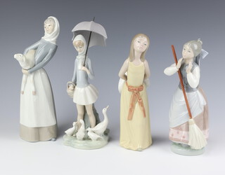 A Lladro figure of a lady holding a broom 24cm, ditto with geese 28cm, another 25cm and a similar of a lady holding a lamb 28cm 