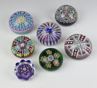 A Perthshire millefiori paperweight no.83 of 300 dated 1997 7cm, a ditto with multi twist floral canes no.54 of 350 7cm, another with floral canes and flowers no.207 of 300 dated 1993 6cm, another no.47 of 250 dated 1996 7cm, another with multi coloured canes 7.5cm, all boxed, together with 2 smaller ditto 6cm and 5cm unboxed  